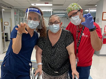 Stella Cogno wears all leopard print during a therapy session and her therapists make cat claws with their hands in support.