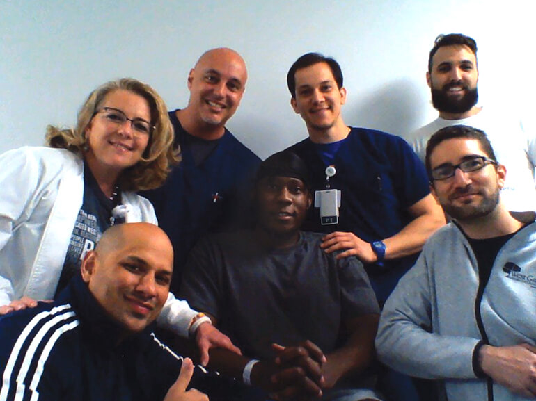 Marlon posing with his therapy care team.